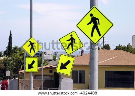 3 cross walk signs in yellow