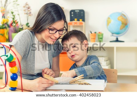 Teacher and Child Playing And Learning at Classroom Royalty-Free Stock Photo #402458023