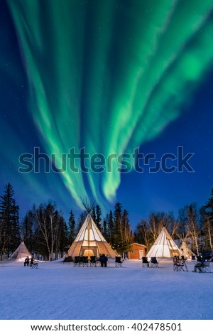 Amazing northern lights high up the Tepees  Royalty-Free Stock Photo #402478501