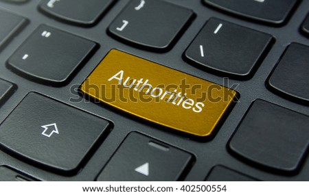 Business Concept: Close-up the Authorities button on the keyboard and have Gold, Yellow color button isolate black keyboard
