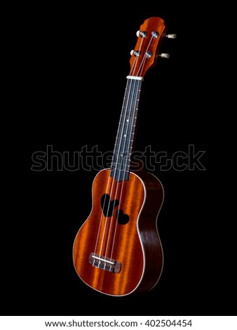 hawaii ukulele guitar isolated against black background, heart sound hole