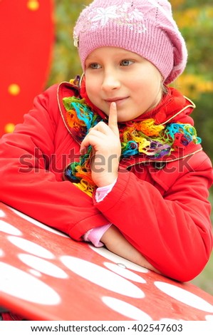 portrait of a girl in a cap and a jacket outdoors