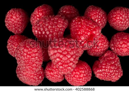 Delicious raspberries on a black background
