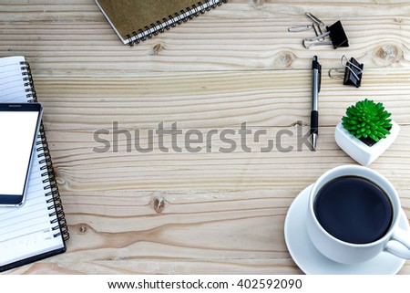 Office desk wood table of Business workplace, smartphone and coffee cup, Top view with copy space.