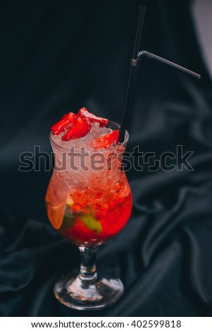 strawberry mojito cocktail served with lime and crushed ice