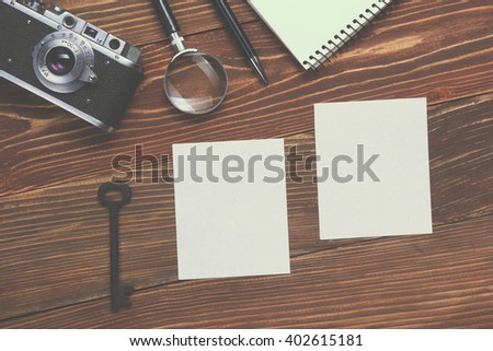 Travel, vacation concept. Camera, notepad, pen, credit card, supplies and photography on office wooden desk table. Top view with copy space for text