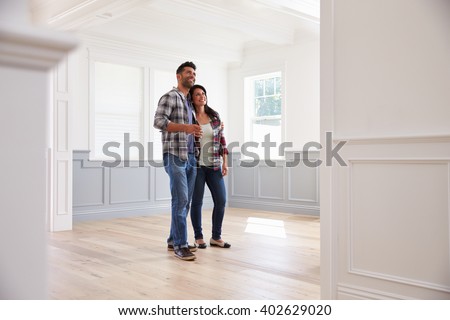Hispanic Couple Viewing Potential New Home Royalty-Free Stock Photo #402629020