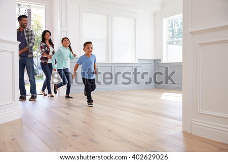 Hispanic Family Viewing Potential New Home Royalty-Free Stock Photo #402629026