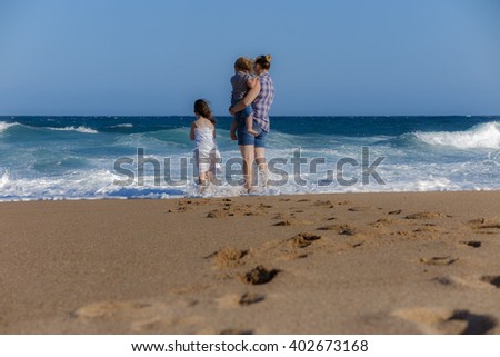 Family is everything. This image is of a mom with her daughters at the beach. You wonder if she alone, sad as she looks at over the sea. Or maybe in awe of the man behind the camera taking the picture
