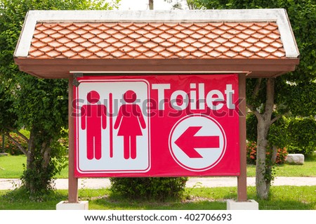 Toilet sign in the park.