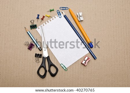 Office tools on cardboard background
