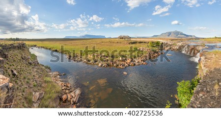 Panoramic view Chirimata river, with some tepuis (table-top mountains) on the background, in Arabopo valley, in Venezuela