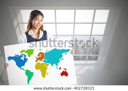 Smiling businesswoman holding a white poster against room overlooking city