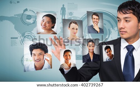 Unsmiling businessman touching against blue world map on white background
