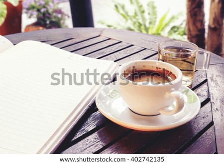 Coffee cup on wooden table - Vintage effect style pictures, over light [blur and select focus background] 