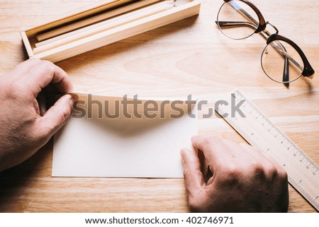 A hands hold a empty white letter