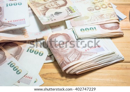 Stylish men's purse with money on wood background