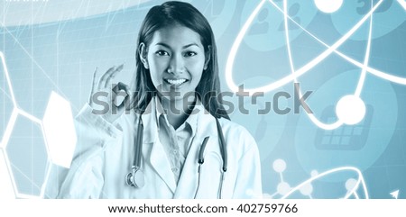 Asian doctor doing ok sign against medical icons