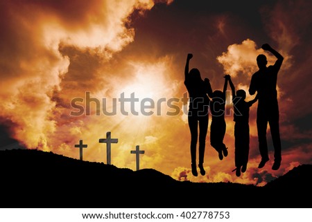Cheerful family jumping against cross religion symbol shape over sunset sky