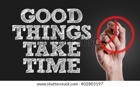 Hand writing the text: Good Things Take Time