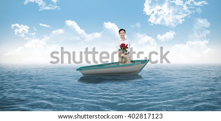 Older asian man offering roses against small boat in the ocean