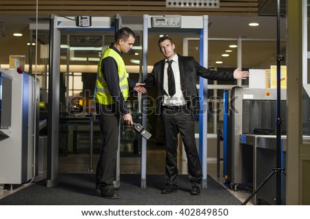 Airport security check at gates with metal detector and scanner  Royalty-Free Stock Photo #402849850