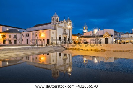 Reflection of the church Santa Maria in Lagos Portugal. Evening scene in front of the town square 