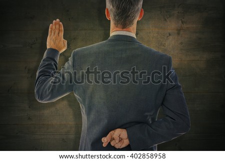Rear view of businessman taking oath with fingers crossed against bleached wooden planks background