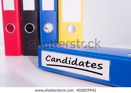 Word candidates underlined against business desk with documents