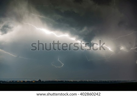 Lightnings over city during thunderstorm in the night