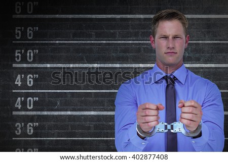 Handsome businessman wearing handcuffs against digital composite image of height measurement