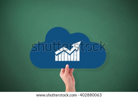 Hand holding cloud against green background