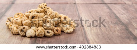 Dried tiger nuts over wooden background