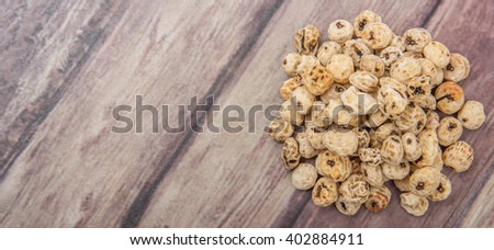 Dried tiger nuts over wooden background