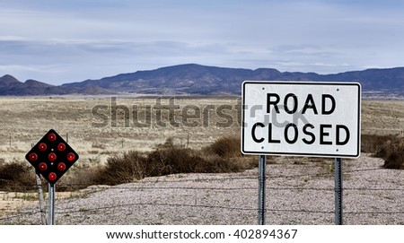 road closed street sign at end of road country landscape and mountains