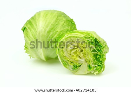 Iceberg lettuce and one cut half, on white background. Royalty-Free Stock Photo #402914185