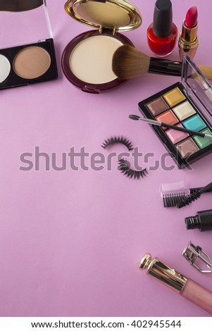 Various makeup products on dark background with copy space,original color tone