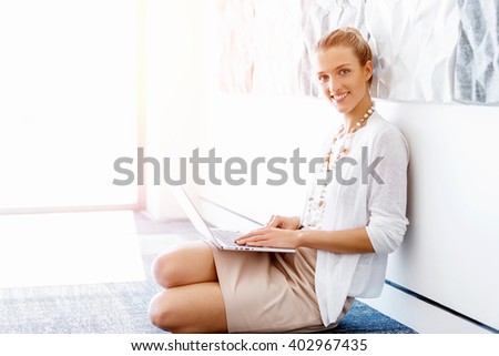 Attractive office worker sitting on floor