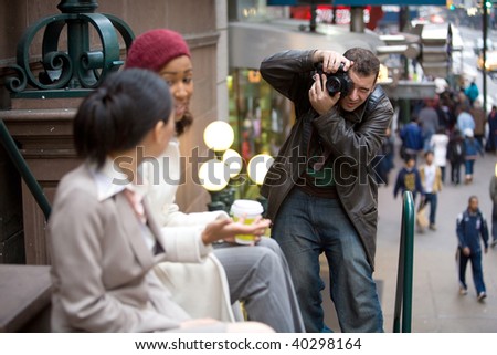 Commercial stock photographer during a photo shoot.  Shallow depth of field.