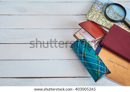 Travel accessories . Preparation for travel, money, passport, note, glasses, map, on wooden table
