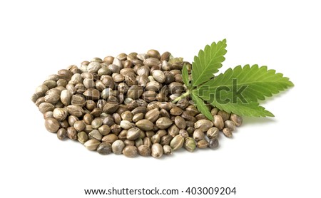 Hemp seeds with a green leaf on a white background Royalty-Free Stock Photo #403009204
