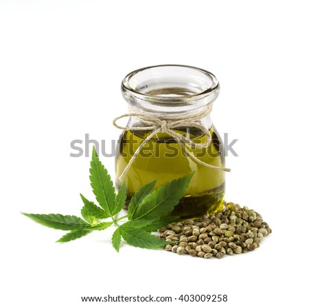 Hemp oil n a glass jar isolated on a white background Royalty-Free Stock Photo #403009258