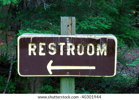 Restroom sign in the forest at Clearwater Falls campground