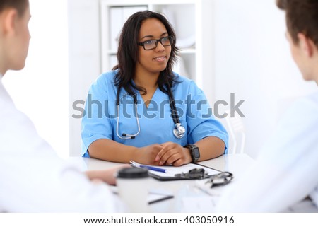 Female african american medical doctor with colleague in hospital