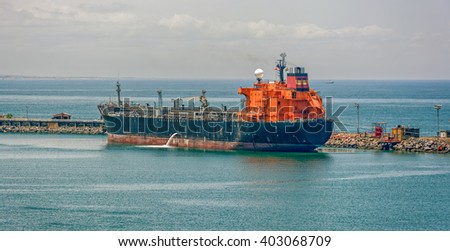 Crude oil tanker pumping ballast water in Lagos, Nigeria, Africa Royalty-Free Stock Photo #403068709