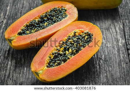 Slice of ripe papayas on wooden table with vintage and vignette, Healthy fruit