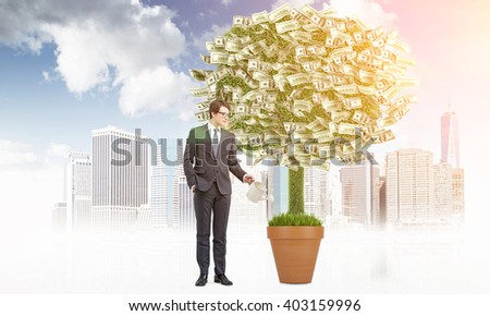 Business growth concept with businessman watering dollar banknote tree on city background