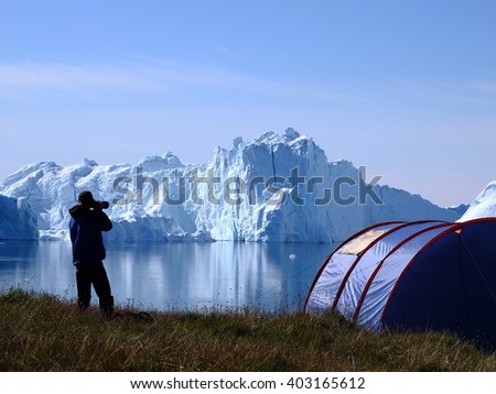 Photographer in icefjord, Greenland