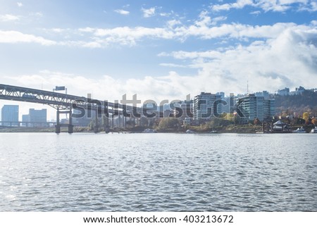 steel bridge over tranquil water with cityscape and skyline of portland 