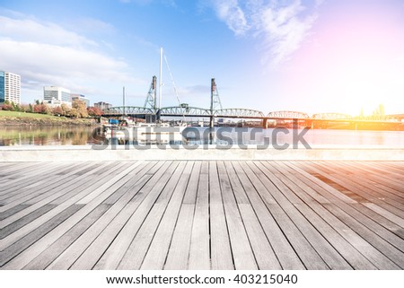 empty wood floor with luxury yacht and bridge at sunrise in portland